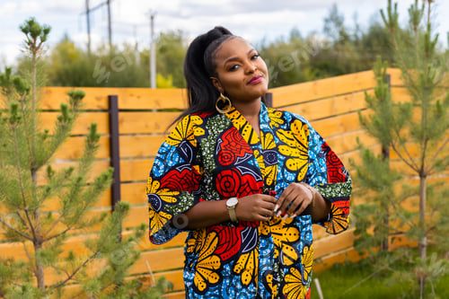Preview: Summer portrait of beautiful african american woman in colourful dress wear standing on backyard