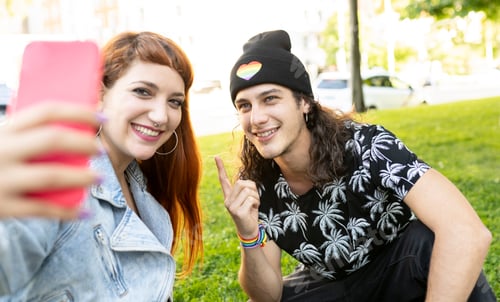 Preview: beautiful couple of funny young man and woman with smarpthone