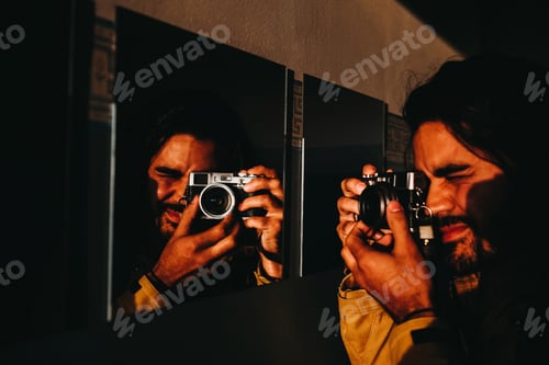 Preview: Man taking through mirror in sunlight