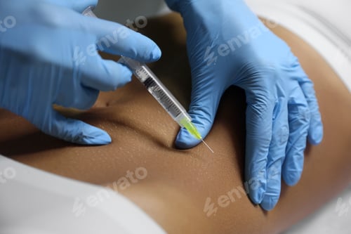 Preview: Young woman getting belly injection in salon, closeup