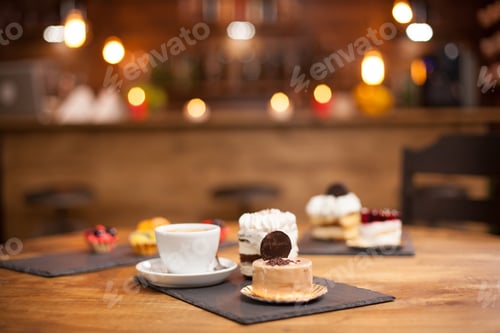 Preview: Various slices of delicious cakes on a wooden table in a coffee shop