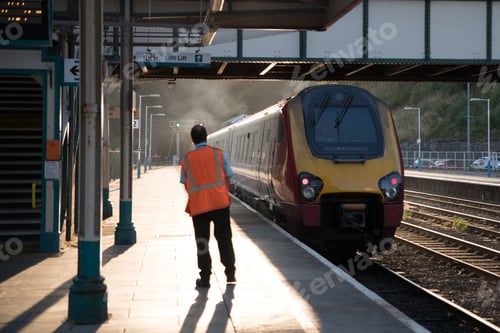 Preview: Station worker looking for an approaching train