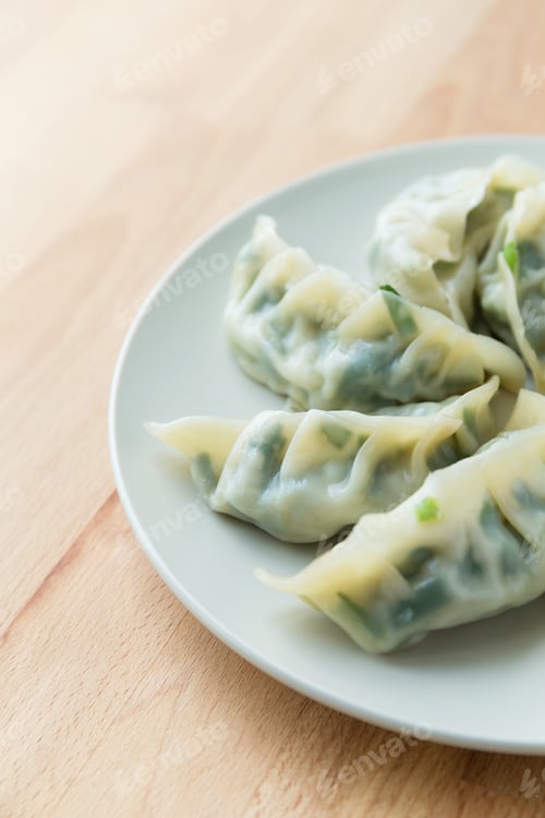 Dumplings on a Plate on a Wood Table