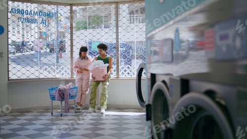 Preview: Love couple chatting laundry room. Teenage girl guy washing clothes in public