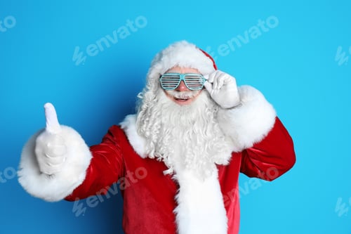 Preview: Authentic Santa Claus wearing funny glasses on color background