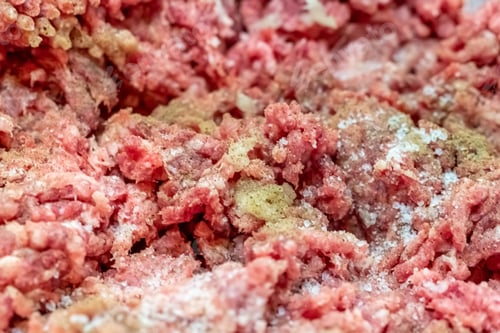 Preview: Closeup shot of uncooked red meat seasoned with salt and pepper