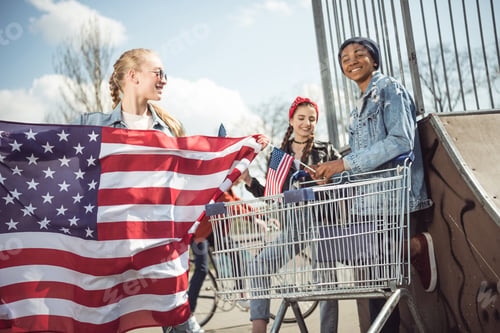 Preview: Teen Friends Celebrate with American Flags in City Park
