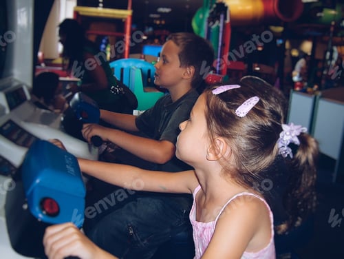 Preview: Young small children playing games at an arcade