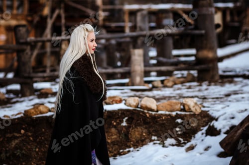 Preview: Beautiful young woman holding a viking with blond hair. Image of Historical figure