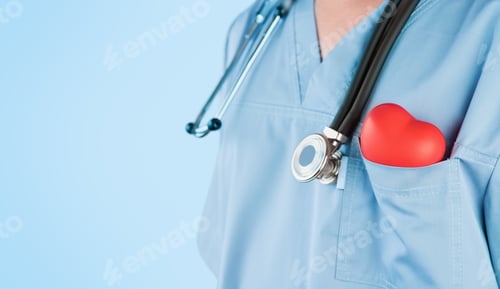 Preview: Male doctor cardiologist holding red heart in pocket of surgical suit and phonendoscope on grey