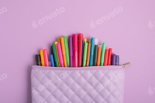 Preview: Pencil case with school supplies on purple g background. Top view. Copy space