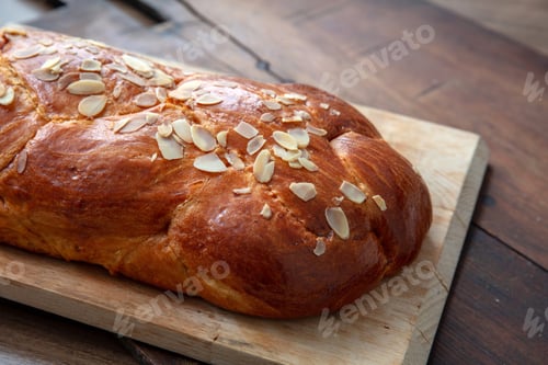 Preview: Easter sweet bread, homemade tsoureki braid on a wooden table, closeup
