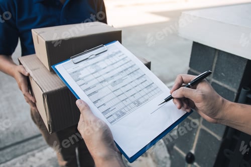 Preview: Delivery young man standing at the door of home and carrying parcels for young male to signing.
