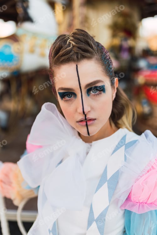 Preview: Sensual street artist standing near carrousel