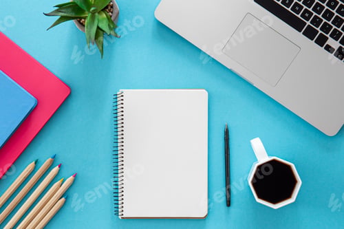 Preview: Flat lay, notepad, laptop and stationery on blue background.