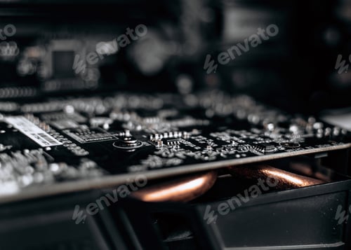 Preview: Close-up photo of dark circuit board of graphics card in desktop computer.