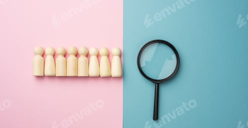 Preview: Wooden figures of men on a blue background and a black magnifying glass