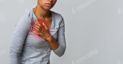 Preview: Black young woman suffering from acid reflux or heartburn