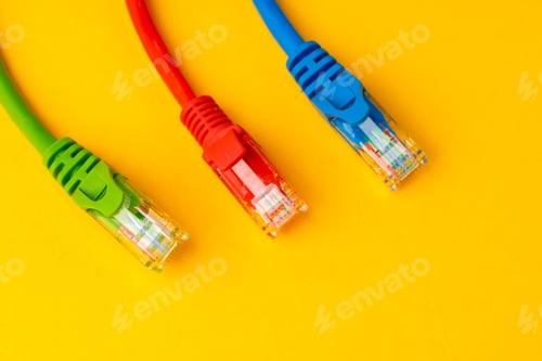 Preview: Network cable on yellow background studio shot