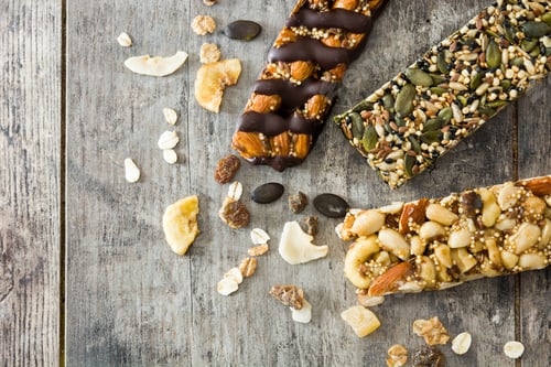 Preview: Protein bars with dried fruits, nuts and seeds lying on rustic wooden table