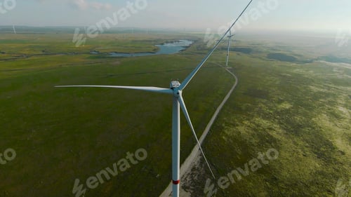 Preview: Flying at wind generators. Shot. Beautiful landscape with wind power generators on green fields