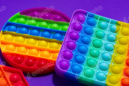 Preview: Colorful antistress pop it toy on purple background