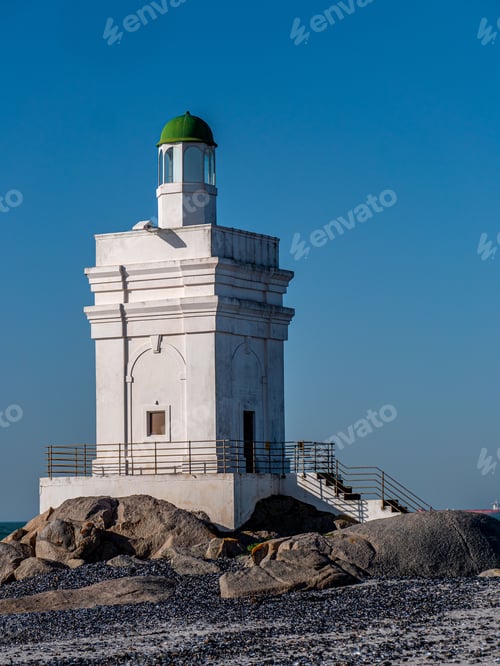 Preview: Shelley Point lighthouse on a rocky beach on a sunny day in South Africa