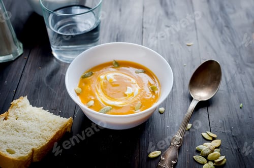 Preview: Pumpkin Soup Garnished with Cream and Seeds