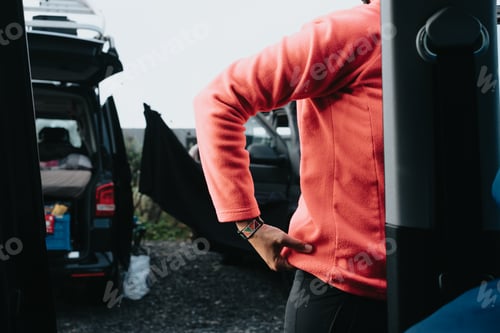 Preview: Adult Wearing Coral Fleece Beside an Open Van
