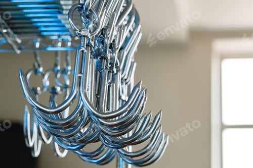 Preview: Metal hooks or hangers in a row in proffesional kitchen