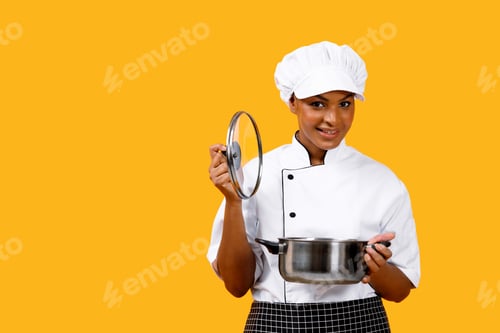 Preview: Nice Recipe. Happy Black Chef Woman Opening Saucepan And Smiling At Camera