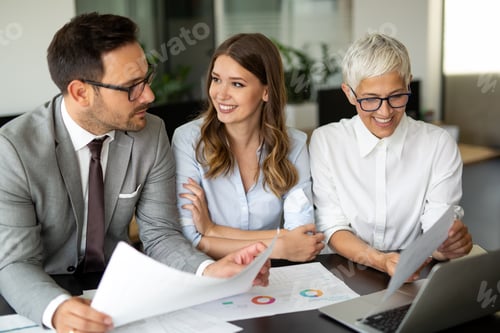 Preview: Group of multiethnic successful business people working and communicating at the office