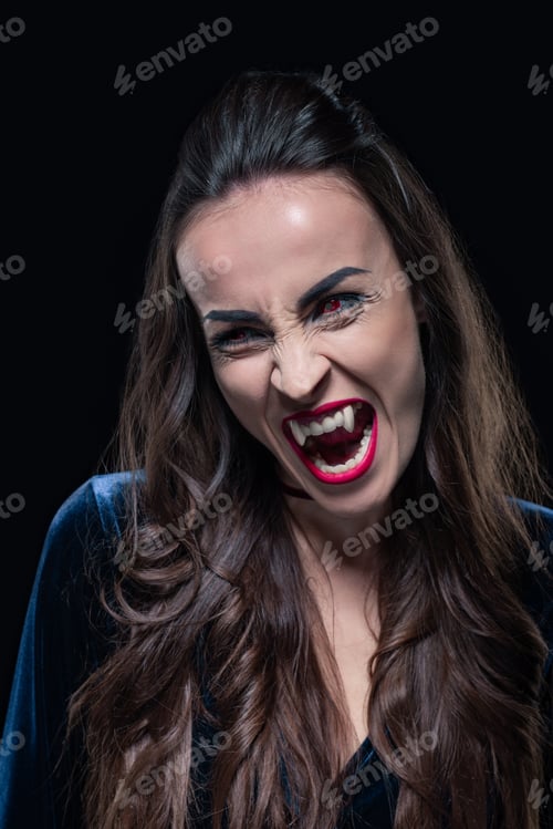 Preview: dreadful woman showing vampire teeth isolated on black
