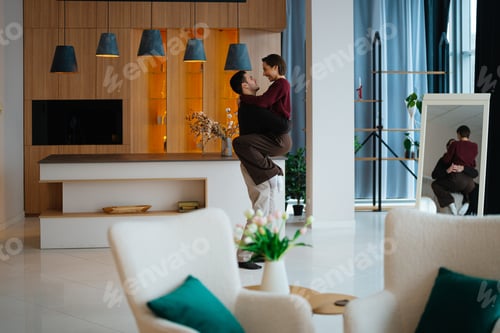 Preview: Couple enjoying a joyful moment in a modern living room setting