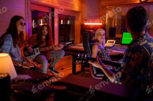 Preview: Professional musicians sitting in studio with sound engineer and making song