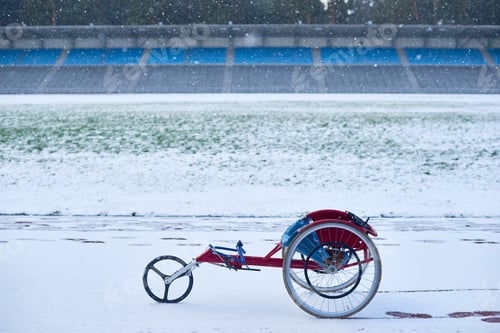 Preview: Modern racing wheelchair standing at outdoor track and field stadium