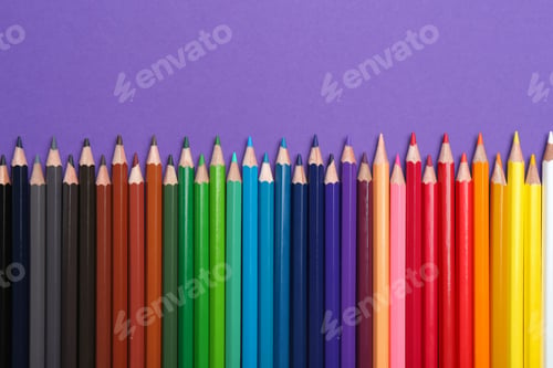 Preview: Colorful pencils on purple background, flat lay