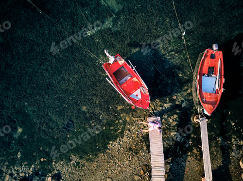 Preview: Man on a wooden pier top view