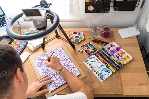 Preview: Vibrant Studio Atmosphere: LGBTQ+ Illustrator Paints with Watercolors