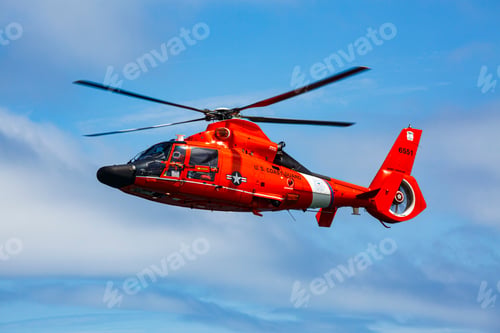 Preview: US Coast Guard helicopter hovering over the water in a demo of a rescue for a sea swimmer.