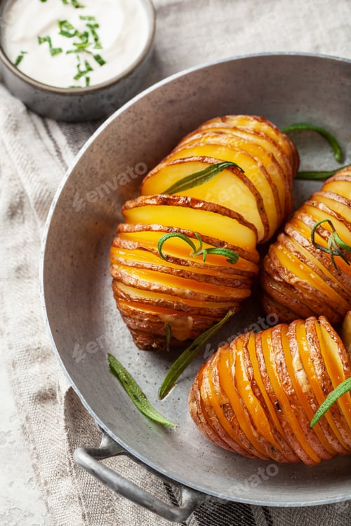 Preview: baked hasselback potato with cheddar cheese and rosemary