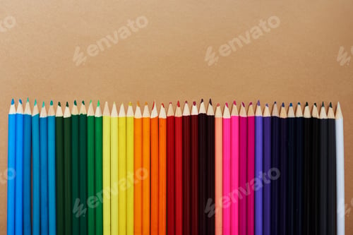 Preview: Studio shot of different coloured pencils against a brown background