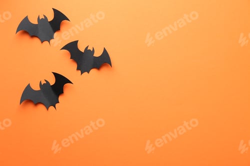 Preview: Halloween decor. Black paper bats on orange background, flat lay. Space for text