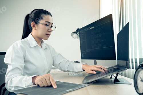 Preview: Software developers are analyzing about the code written into the program on the computer