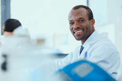 Preview: young doctors in uniform working at testing laboratory, chemical laboratory