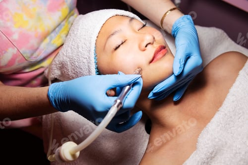 Preview: woman receiving an exfoliating facial treatment