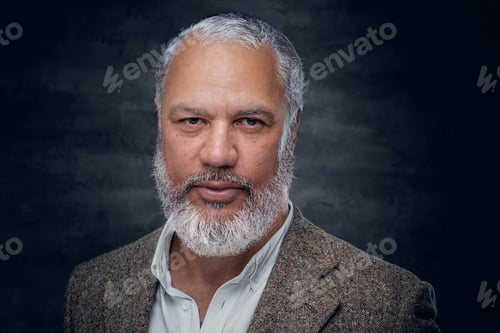 Preview: Elegant old man dressed in beige suit against dark background
