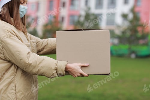 Preview: Woman Delivering Package Wearing Medical Mask and Santa Hat