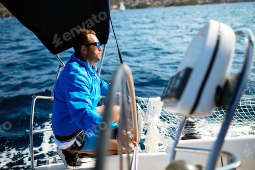 Preview: Handsome strong man sailing with his boat