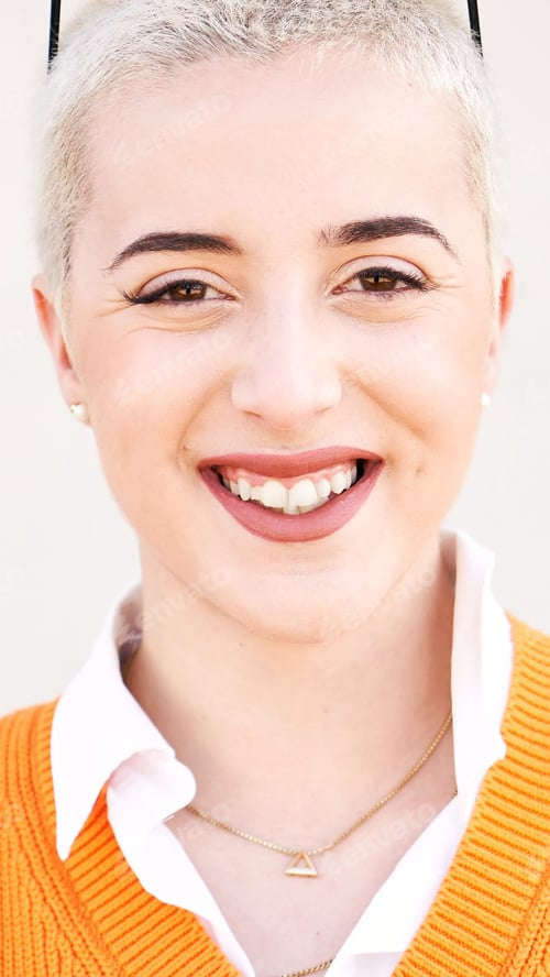 Preview: Vertical Portrait of young woman looking at camera. Close up face of cheerful girl smiling outdoor.